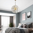 Hand-Blown White Glass Flower Chandelier, 24 in, over a bed in a grey-walled bedroom