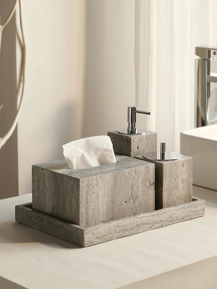 Gray travertine tissue box cover and soap dispensers on a matching travertine tray