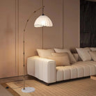 Bamboo arc floor lamp arching over a white sofa
