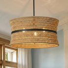 Natural rattan four-light drum pendant with a dark center band, close-up