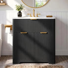 Black fluted vanity with brass faucet under a round mirror