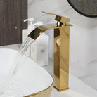 Gold vessel sink with white interior on a marble vanity