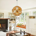 Amber glass flower chandelier in a family room with fireplace