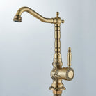 Antique brass gooseneck basin faucet with carved details