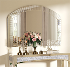 Front view of the arched Venetian glass mirror styled with candlesticks and pink florals