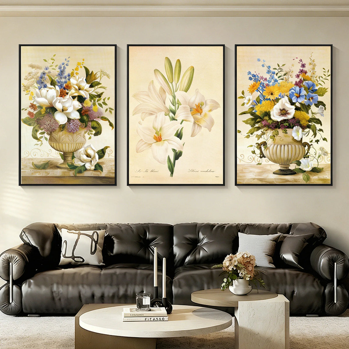 Three vintage floral still-life prints hung above a leather sofa in a living room