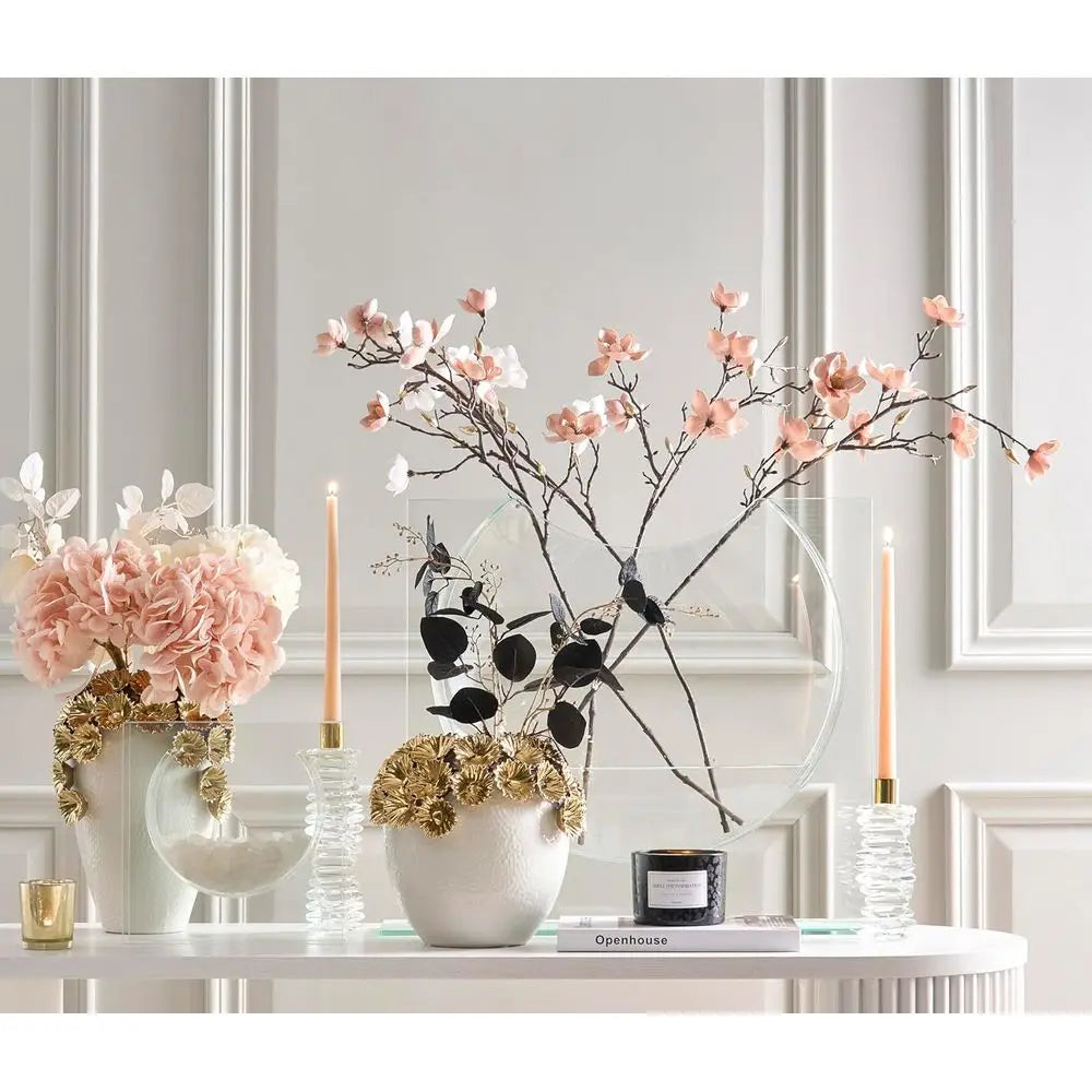 Clear glass ellipse vase styled on a white console