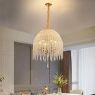 Gold waterfall chandelier with strands of crystal-look beads over a dining room