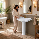 White ceramic pedestal sink in a bright bathroom