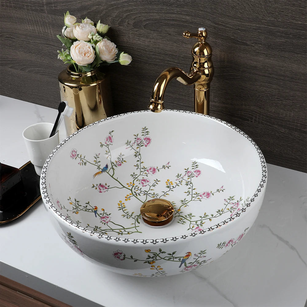 Flower-and-bird porcelain basin seen from above, gold faucet running