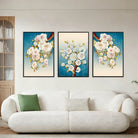 Three framed white blossom prints in a living room