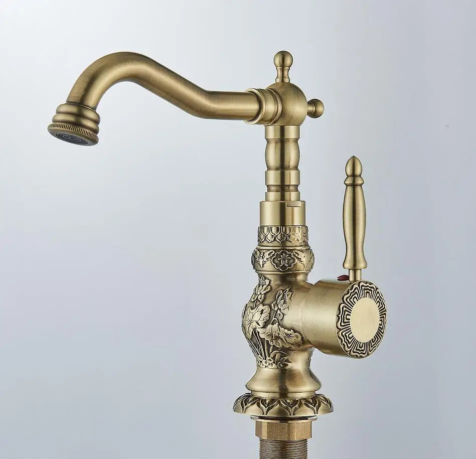 Tall carved antique brass basin faucet, front view
