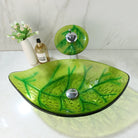 Green Leaf Tempered Glass Vessel Sink Set, on a white counter with waterfall faucet