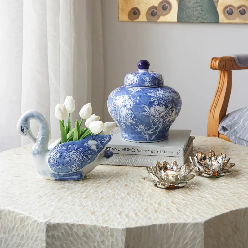 Blue and white porcelain lidded jar on a side table with white tulips