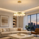 Round alabaster-look pendant lit above a living room with city views