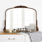 Front view of the antique gold baroque mirror leaning on a dresser reflecting windows