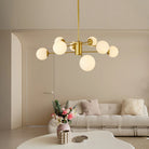 Gold globe chandelier above a living room sofa