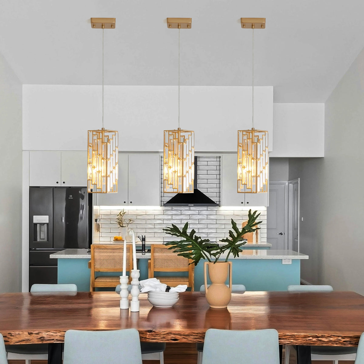 Set of 3 gold crystal pendant lights in a dining area