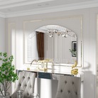 Extra-large arched Venetian mirror framed by wall molding above a dining console