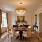 Gold raindrop crystal chandelier over a dining table