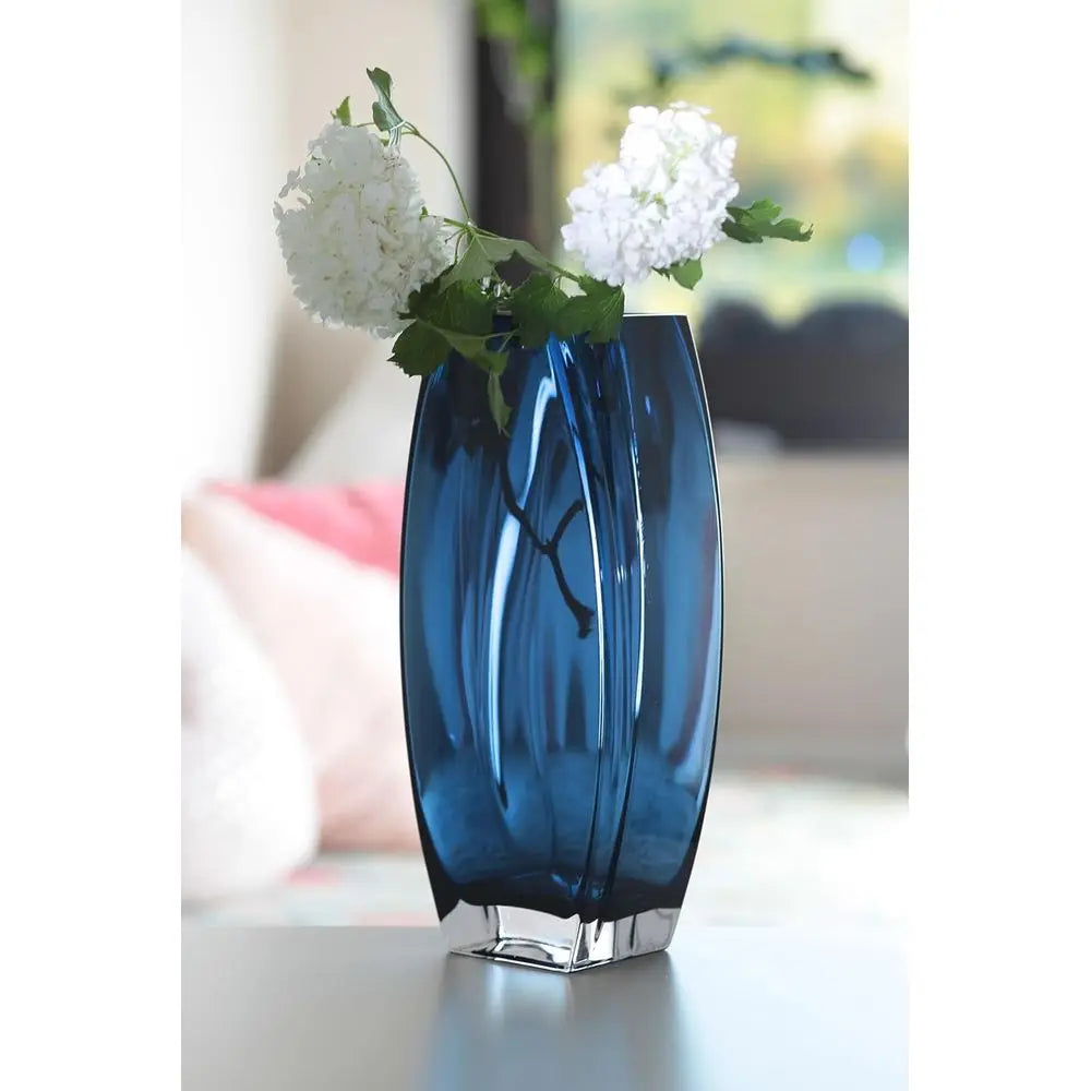 Blue-teal art glass vase with white blooms