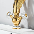 Gold swan-neck basin faucet with two crystal handles and white porcelain base