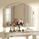 Extra-large arched Venetian glass mirror with beveled border above a mirrored console and roses
