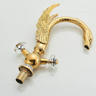 Gold swan-neck basin faucet, side view with crystal handles