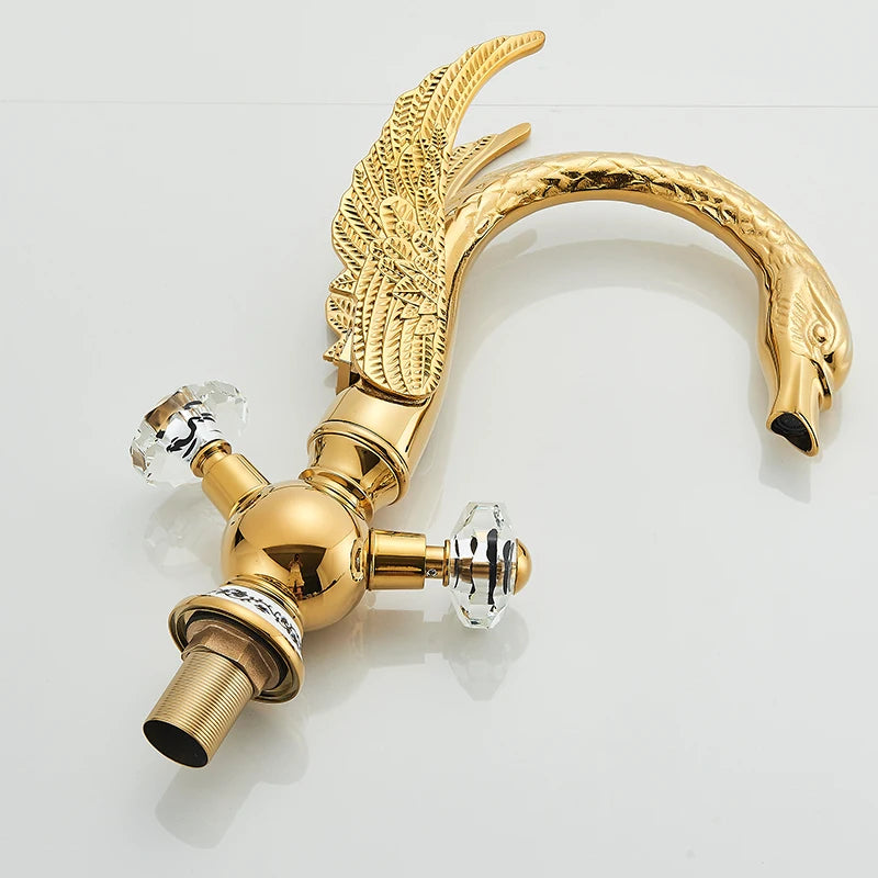 Gold swan-neck basin faucet, side view with crystal handles