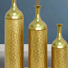 Close-up of the embossed leaf pattern on gold metal vases