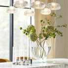Clear glass ellipse vase on a marble dining table