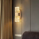 Textured ripple glass LED wall sconce glowing beside a window