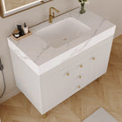 White vanity with marble-look top and integrated basin, angled view
