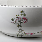 Close-up of the painted blossom pattern on the outside of the porcelain sink