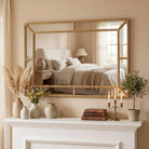 Gold beaded mirror above a console in a living room