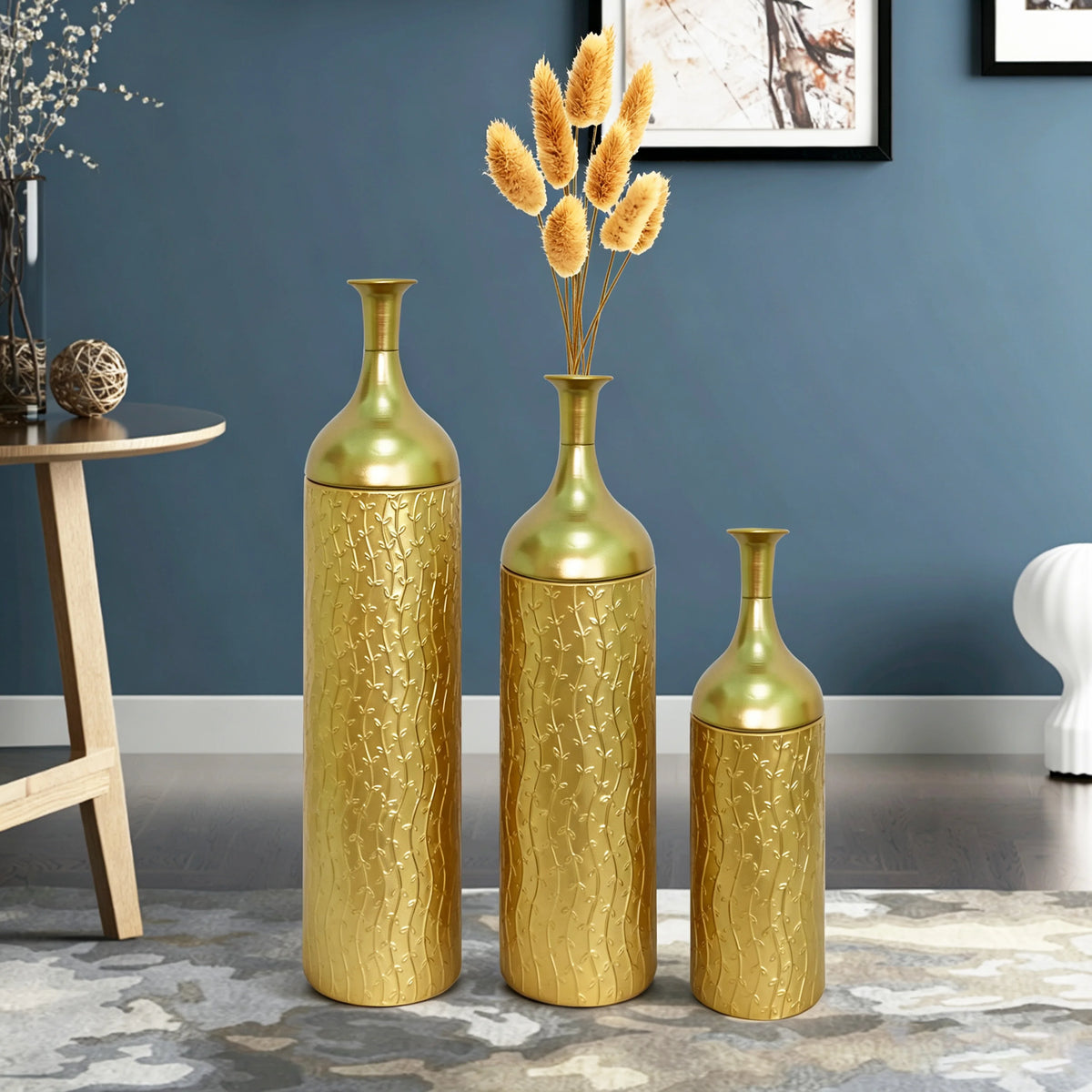 Gold floor vases against a blue wall