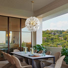 Hand-Blown White Glass Flower Chandelier, 24 in, above a dining table with garden views