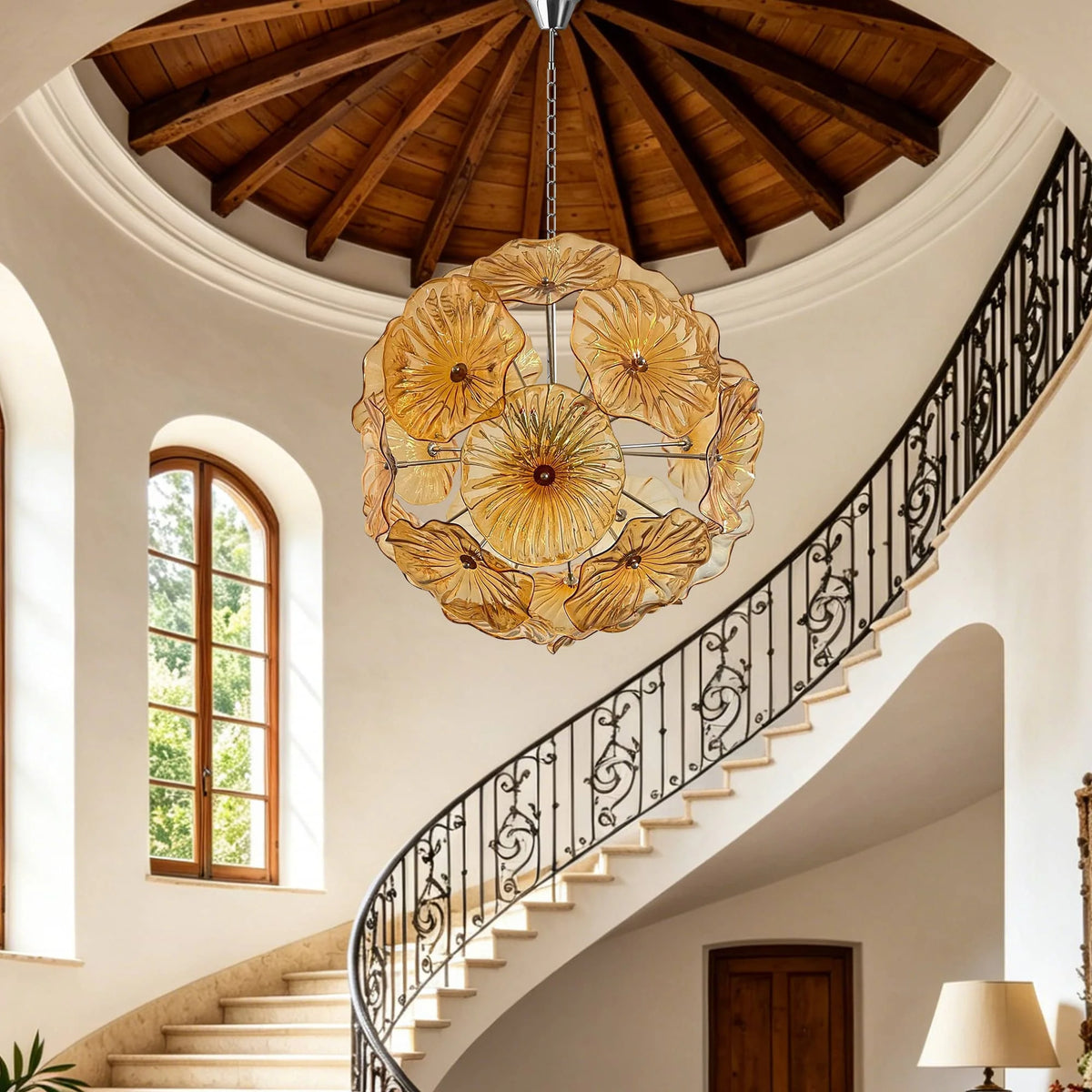 Amber glass flower chandelier in a domed entry with curved staircase