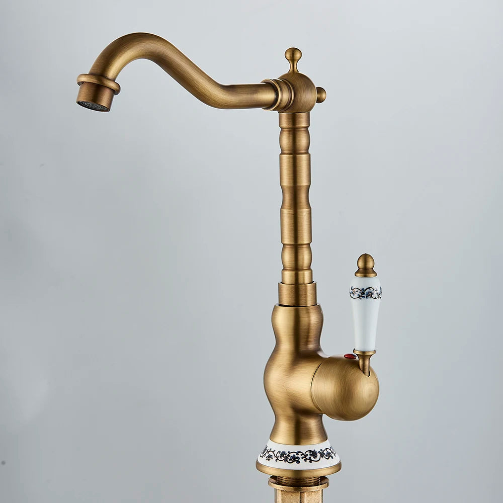 Carved antique brass swivel faucet, side view