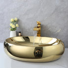 Gold oval vessel sink with waterfall faucet running