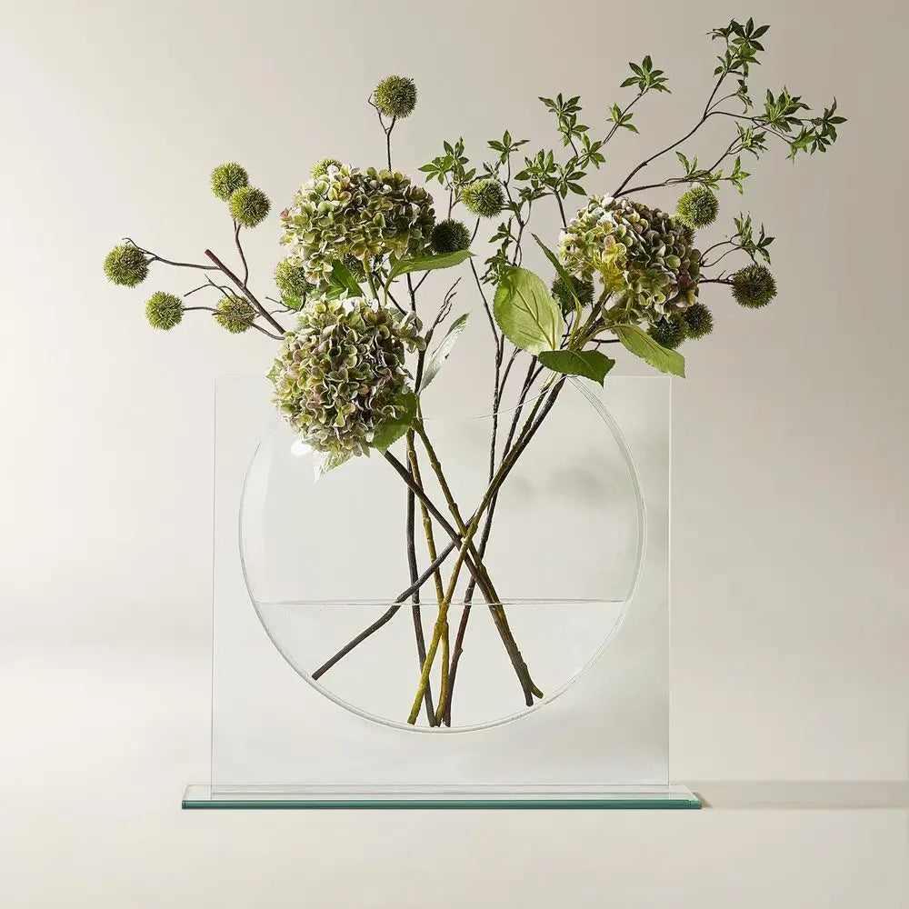 Clear glass ellipse vase with green hydrangea stems