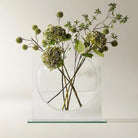 Clear glass ellipse vase with green hydrangea stems