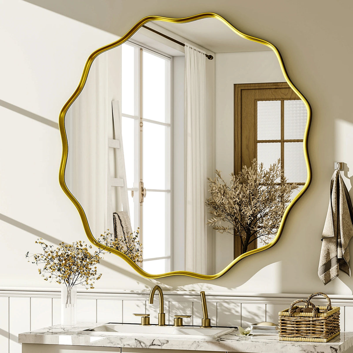 Wavy scalloped round wall mirror with gold frame above a marble bathroom vanity