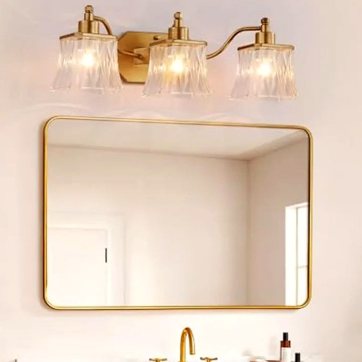 Close-up of the ribbed crystal-glass shades on the gold vanity light