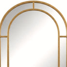 Close-up of the beaded gold arch crown on the wall mirror