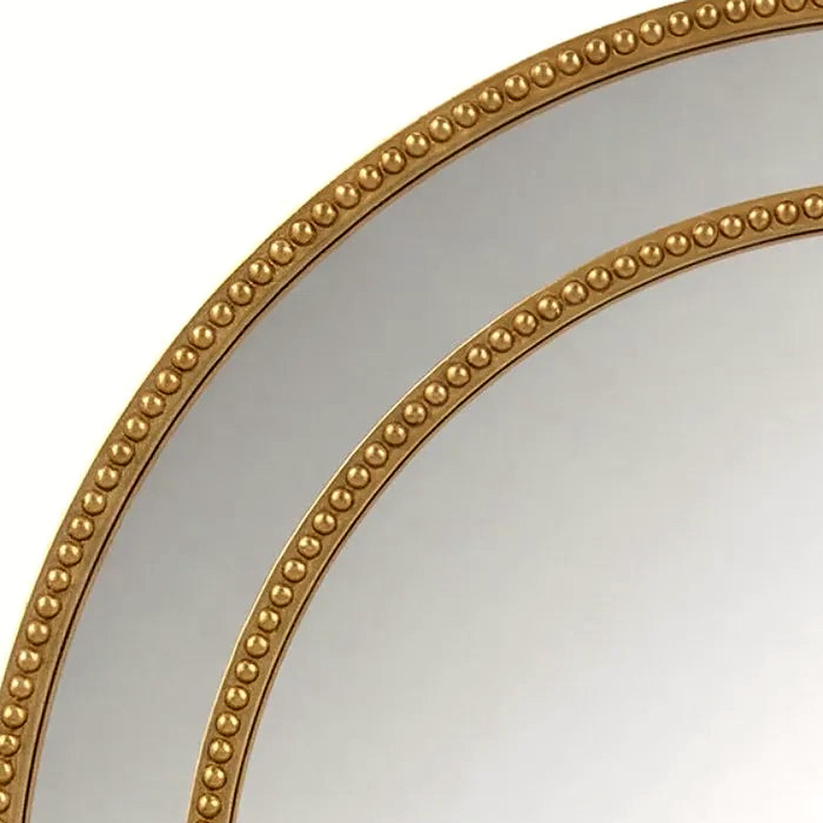 Close-up of the beaded gold outer ring on the round wall mirror