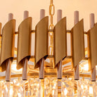 Close-up of cascading clear raindrop crystals on the gold five-tier chandelier