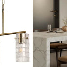 Close-up of the clear textured glass shades on the brass linear pendant
