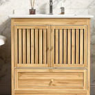 Close-up of the vertical bamboo fluting and gold knobs on the vanity doors