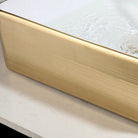 Close-up of the horizontal gold stripe texture on the ceramic vessel exterior